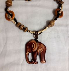 Shop now large boho wooden necklace with a cute elephant charm! This long vintage hippie chaplet is made of wood beads and elephant pendant. Wonderful Christmas gift for someone you love. Necklace' length is 22 inch, pendant length 2.5 inch  See more necklaces here https://www.etsy.com/shop/AttictreasurebyInna?ref=seller-platform-mcnav&section_id=23625255  Choose your favourite. It is packed in a cute gift wrap.  Just add it to cart and enjoy your new fantastic look! All the items in my shop are vintage or antique and have been previously used. Items can show wear traces, normal for their age and any major flaws will be noted. Many enlarged close, detailed photos are taken for you to view. You can find the definitions of conditions in the item's description. Although I do my best, photogra Bohemian Wooden Necklace For Gift, Bohemian Wood Necklace For Gift, Bohemian Wood Necklaces Perfect For Gifts, Bohemian Wood Necklace As Gift, Bohemian Wood Necklace Perfect As A Gift, Bohemian Brown Necklace With Wooden Beads, Brown Wooden Beaded Necklaces For Festivals, Handmade Brown Hippie Necklaces, Handmade Brown Hippie Necklace