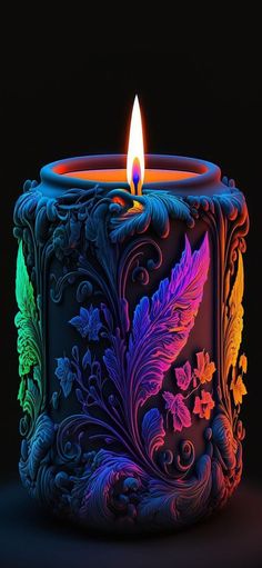 a colorful lit candle sitting on top of a table