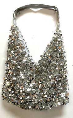 This cool purse is fully sequin beaded front & back tip to tip. Perfect for pairing up with your costume or to carry with you in event! Evening Bags With Sequins For Party Season, Glamorous Sequin Bag For Night Out, Sequin Bags For Night Out And Party Season, Glamorous Party Bags With Sequins, Glamorous Sequin Party Bags, Glamorous Beaded Sequin Fabric For Party, Silver Embellished Bags For Party, Silver Embellished Party Bag, Glamorous Silver Embellished Bags