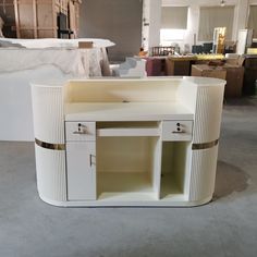 a white cabinet sitting inside of a room filled with boxes and other furniture in the background