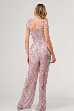 Make a fashion statement with the Printed Tie Shoulder Wide Leg Jumpsuit, a chic and versatile piece for your wardrobe. The tie shoulder detailing adds a touch of charm and character to this stylish jumpsuit. Featuring a trendy print, the wide leg silhouette exudes a relaxed and contemporary vibe that is perfect for any occasion. Dress it up with heels for a sophisticated look or opt for sandals for a more casual feel. Features: Smocked, Tied, Ruched, Pocketed, Frill Sheer: Opaque Material compo Chic Floral Print Jumpsuits And Rompers For Brunch, Chic Floral Print Jumpsuits For Brunch, Chic Printed Jumpsuits And Rompers For Brunch, Chic Printed Jumpsuit For Vacation, Chic Printed Jumpsuits And Rompers For Vacation, Chic Printed Jumpsuits And Rompers For Party, Feminine Sleeveless Jumpsuits And Rompers For Brunch, Trendy Sleeveless Jumpsuits And Rompers For Brunch, Spring Vacation Jumpsuits And Rompers With Tie Straps