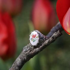 Victorian style German Tulip Cameo.  Available on an antiqued brass or silver vintage ring.I do not recommend that this be worn while bathing or swimming although normal handwashing is fine. Vintage Enamel Cabochon Rings, Handmade Antique Silver Vintage Rings, Handmade Vintage Antique Silver Rings, Vintage Antique Silver Open Ring Jewelry, Vintage White Oval Cabochon Ring, Vintage Silver Flower Ring For Jewelry Making, Vintage Silver Flower Ring Gift, Vintage Silver Flower Ring For Gift, Silver Vintage Flower Ring For Gift