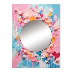 a mirror that is sitting on top of a piece of paper with paint splatters