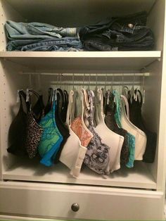 an organized closet with clothes and bras