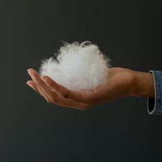 a person holding cotton in their hand