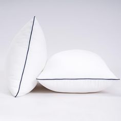 two white pillows sitting next to each other