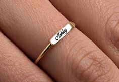 This Simple Name Ring is 14k Solid GOLD ( not filled or plated) You can customize this name ring with the name/word/date/mantra of your choice. Gold Name Ring is the best jewelry you could ever find. This will be the best gift for you and your loved one. All our gold/silver rings are suitable for Customizable Adjustable Gold Engraved Ring, Customizable Nameplate Rings As Gifts, Customizable Nameplate Rings For Gifts, White Engraved Ring For Promise With Name, Customizable Gold Engraved Ring As Gift, Customized Gold Engraved Ring As Gift, Nameplate Engraved Ring For Gift, Customized Gold Engraved Ring For Gift, 14k Gold Engraved Nameplate Ring For Gift