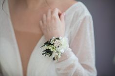 a close up of a woman wearing a wedding dress and holding her hands to her chest