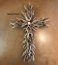 a cross made out of branches on a table