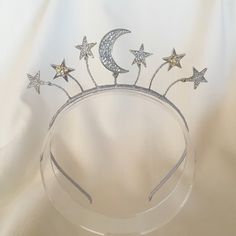 Drawing inspiration from all things celestial, the Star Collection is both whimsical and striking. The galactic trend is a versatile look perfect for a wide range of occasions. A fun and cute little boho tiara featuring the moon and stars hand wired onto a satin wrapped band. To shop more items from the Star Collection: https://www.etsy.com/au/shop/MerineDesigns?ref=simple-shop-header-name&listing_id=711775814&section_id=26869808 Boho Tiara, Jewel Drawing, Starfish Ring, The Moon And Stars, Luna Moon, Star Headband, Hair Wreaths, Boho Headband, Wedding Tiara