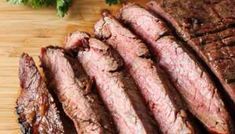 sliced steak on a cutting board with parsley