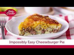 a piece of cheeseburger pie on a white plate with a red and white checkered tablecloth