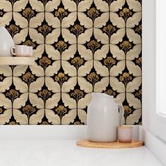 a white vase sitting on top of a counter next to a wallpapered wall