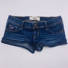 Euc Hollister California Denim Blue Jean Shorts Size 1 (W 25) Details - Juniors' Denim Jean Shorts Dark Wash Blue Fading & Whiskering Throughout Slim Fit Double Front Button Closure W/ Zipper Fly Belt Loops Five-Pocket Style Cotton/Elastane Blend Imported Approx. Measurements - Total Length 7.5" Inseam 1.75" - 2" Condition - This Item Is In Excellent Condition. You Might Even Mistake It For Brand New! See Images For Wear Cute Shorts Denim, Cute Low Rise Jeans, Dark Wash Denim Shorts, Jean Shorts Png, Denim Shorts Aesthetic, Low Waisted Jean Shorts, Y2k Jean Shorts, 2000s Shorts, Lowrise Shorts