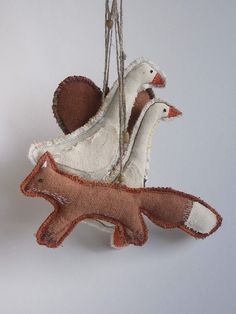 an ornament with two birds hanging from strings