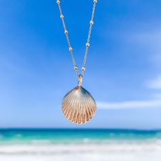 Wear your seashell and be reminded that with all the ups and downs that life brings, the waves will always bring you where you need to be. The gold shell charm has been cast from a seashell that washed up on the beach on the island of Nevis, West Indies. It has been cast into recycled 14k gold using the lost wax method and contains all the beautiful nooks and crannies of the original shell. Seashell Pendant: ~16mm recycled solid 14k yellow gold Chain: 14k gold satellite chain Due to the handmade Ocean-inspired Yellow Gold Beach Jewelry, Yellow Gold Starfish Charm Necklace For Beach, Yellow Gold Necklace With Starfish Charm For Beach, Gold Shell-shaped Necklace With Starfish Charm, Shell-shaped Ocean-inspired Jewelry With Starfish Charm, Ocean-inspired Shell Necklace With Pearl Charm, Gold Necklace With Starfish Charm, Coastal Style Gold Strand Jewelry, Ocean-inspired Yellow Gold Jewelry