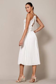 Elevate your formal attire with the Marilyn White Pleated Midi Dress. Featuring an apron neck, modern corset waist, and back tie, this plisse dress adds allure to any event. With its sophisticated design and charming details, you'll feel confident and polished. Perfect for both formal events and cocktail parties. White Tie-back Midi Dress For Formal Occasions, Chic A-line Ruched Dress, Backless Midi Dress With Ruched Back For Cocktail, Backless Cocktail Midi Dress With Ruched Back, Backless Midi Dress With Ruched Bodice For Cocktail, Backless Cocktail Midi Dress With Ruched Bodice, Evening Midi-length Ruched Backless Dress, Evening Ruched Midi Backless Dress, Evening Ruched Backless Midi Dress