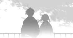 two people standing next to each other in front of clouds