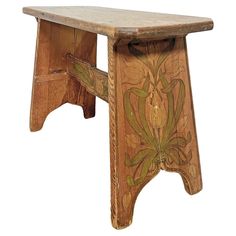 a wooden bench with floral designs painted on it