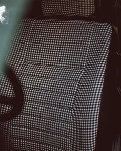 a black and white checkered couch sitting next to a table