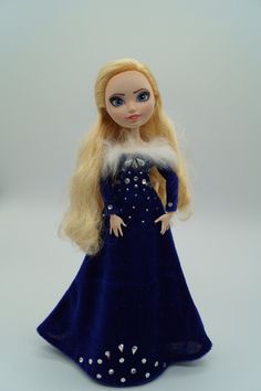 a doll with blonde hair wearing a blue dress