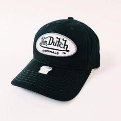 DEADSTOCK VON DUTCH CAP, STILL WITH TAGS AND ORIGINAL PACKAGING 100% AUTHENTIC, BRAND NEW WITH TAGS. Vintage black Von Dutch cap / Von Dutch Cap / Von Dutch trucker cap / Von Dutch hat Classic white Von Dutch logo graphic embroidered on front 90s Y2K Cap FULLY TRACKED SHIPPING SERVICE. UK AND WORLDWIDE SHIPPING. Vintage Black Baseball Cap With Letter Print, Vintage Black Trucker Hat With Embroidered Logo, Retro Black Six-panel Baseball Cap, Vintage Black Hat With Logo Patch, Vintage Black Baseball Cap, Vintage Black Hat With Embroidered Logo, Vintage Black Fitted Baseball Cap, Black Vintage Hat With Logo Patch, Black Vintage Style Baseball Cap