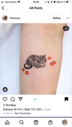 a small cat tattoo on the arm