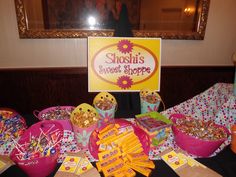 the table is set up with candy and candies for someone's sweet shoppe