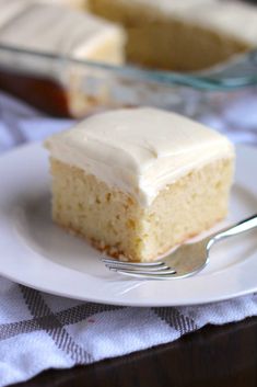 a piece of cake on a plate with a fork next to it and another slice in the background