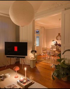 a living room filled with furniture and a flat screen tv sitting on top of a wooden table