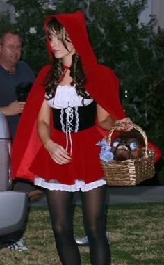 a woman dressed in a red riding hood and holding a basket