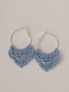 the crocheted hoop earrings are made with silver plated earwires and have blue yarn on them