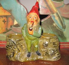 a gnome figurine sitting on top of a wooden table