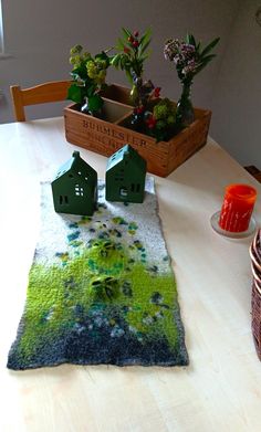 a table with two green houses on it