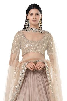 Moon grey lehenga with attached cancan, and mirror embroidered broad border. Comes with embroidered padded blouse and dupatta.
Components: 3
Pattern: Embroidered
Type Of Work: Mirror
Neckline: Scoop
Sleeve Type: Short
Fabric: Net
Color: Grey
Other Details: 
Pleated lehenga
Closure: Lehenga and blouse: Side zips
Occasion: Wedding,Bride - Aza Fashions Choli With Sheer Dupatta For Reception Navratri, Festive Choli With Sheer Dupatta For Reception, Wedding Embellished Sets For Diwali, Embellished Wedding Sets For Diwali, Floor-length Embellished Blouse For Wedding, Eid Wedding Pre-draped Saree With Mirror Work, Reception Choli With Sheer Dupatta In Traditional Drape, Reception Choli With Sheer Dupatta And Traditional Drape, Navratri Organza Chandbali Choli