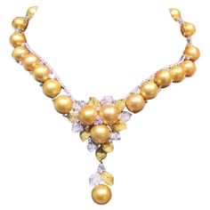 The Following Item we are offering is this Extremely Rare Beautiful 18KT Gold Fine Extraordinary Large Cultured South Sea Golden Pearl Diamond Necklace. This Masterpiece of a Necklace is comprised of over 6 Carats of Fine Fancy Glittering Round White Diamonds and aprrox 4.50CTS of Fancy Yellow Diamonds!! The Golden Pearls are of Extremely Rare and Exquisite and Highly Lustered AA-AAA Quality, giving off a Magnificent Radiance and Color!! The Diamonds are of Exquisite and Fine Quality. This Magnificent Breathtaking Necklace is from a Private Top Manufacturer that sold to Select Important 5 Star Hotels and Fine Jewelry Stores and Comes New With Tags $67,300 with Certified Appraisals!!! Luxury Yellow Beaded Jewelry, Luxury Yellow Gold Pearl Necklace For Anniversary, Pearl Diamond Necklace, Yellow Diamond Necklace, Dressy Hats, Golden Pearl, Pearl And Diamond Necklace, Yellow Diamonds, Fancy Yellow Diamond