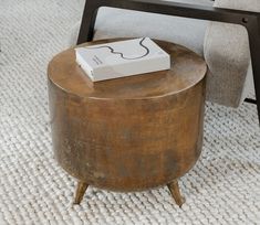 a box sitting on top of a wooden table next to a chair in a living room