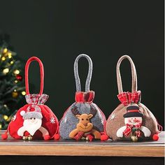 three small christmas bags sitting on top of a table