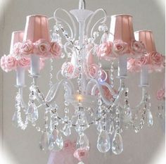 a pink chandelier with roses on it