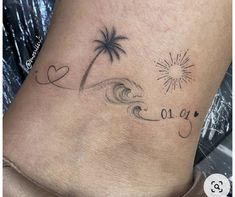 a woman's foot with a tattoo on it that says love and two palm trees