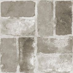 a brick wall with several different shades of gray