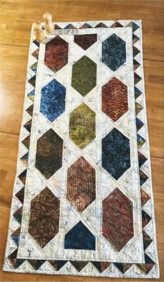 a quilted table runner on the floor