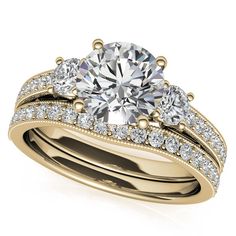 a diamond engagement ring set with two matching bands on the band, and a round cut diamond