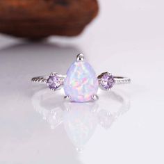 When it comes to the most stunning jewelry designs, we absolutely adore our gorgeous April Opal and Amethyst set. We've made each ring set with love by hand  using our premium sterling silver.  Finished with beautiful natural crystals, it's a design we know you will adore. ✦ DETAILS ✦ ✧ Purple fire opal and natural crystals  ✧ Sizes 3.75-11.25 ✧ This ring  will arrive ready to gift in a Kherish Jewelry Pouch. ✧ Due to the nature of the handmade process, each piece may slightly vary in color, size, shape, and contain natural inclusions. Every piece is gorgeous and one of a kind.  *Please refer to photos for reference.  ✦ This Artist Has Autism✦  Every item you order from Kherish is  handcrafted and packed by an artist with autism in RVA. Thanks to your support we are living our dreams.   Co White Cubic Zirconia Jewelry For Birthday, White Cubic Zirconia Birthday Jewelry, Teardrop Gemstone Jewelry For Birthday, Elegant White Amethyst Ring Gift, Elegant Purple Jewelry For Birthday, Cubic Zirconia Jewelry With Accent Stones For Birthday, White Gemstone Jewelry For Mother's Day, Adjustable Purple Jewelry For Birthday, Hypoallergenic Lavender Sterling Silver Jewelry