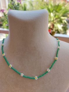 A pretty necklace perfect for everyday wear. So cute and dainty this layering necklace looks lovely on it's own on layered with other necklace. Daisy beaded necklace is an excellent and elegant gift for your lovelies. Choker necklace is made of white and green bead. You can wear the seed bead necklace to a wedding party and look very special. This tiny choker is made of glass beads. Please select necklace length from the drop-down menu or request an arbitrary length. If you would like a bigger/smaller size please contact me. You can press the contact button. Summer Flower Charm Necklace As A Gift, Summer Flower Charm Necklace As Gift, Summer Flower Charm Necklace For Gift, Cute Flower Necklace For Summer, Cute Flower Necklaces For Summer, Summer Gift Necklace With Flower Charm, Trendy Flower-shaped Summer Jewelry, Summer Floral Beaded Chain Necklace, Trendy Handmade Daisy Jewelry