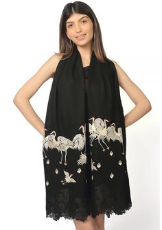 Made from a luxurious cashmere, this black scarf envelops you in warmth and softness. The elegant beige-colored embroidered cranes on the scarf add a touch of grace and oomph, capturing the beauty of nature. Adding to the allure of this unique scarf is a distinctive tonal black Chantilly lace application, making it a collector's piece. Wrap yourself in luxury and make a statement with this exquisite scarf. Luxury Resham Embroidery Shawl Scarf, Luxury Black Embroidered Pashmina Shawl, Luxury Pashmina Shawl With Embroidered Border, Luxury Embroidered Elegant Pashmina Shawl, Luxury Traditional Scarves With Intricate Embroidery, Traditional Black Silk Scarves, Elegant Embroidered Pashmina Silk Scarf, Black Embroidered Silk Shawl, Traditional Black Silk Shawl