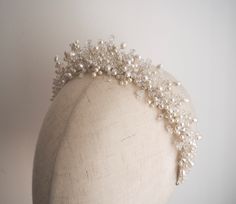 The Celine crown is crystal and freshwater pearl adorned headpiece on a fine silver band. A modern, eye-catching piece to elevate your bridal look. All pieces are designed and handmade in England, using high quality beads and embellishments, tarnish free jewellery wire and a comfortable headband base ideal for wearing over long periods of time.  LEAD TIME Made to order in 2-3 weeks, plus delivery time.  UK Delivery: 2-5 working days (Royal Mail Tracked) International Delivery: 5-10 working days (International Tracked & Signed) RUSHED ORDERS Please get in touch if you need your piece sooner. This is sometimes possible with a rushed order fee but entirely depends on the design and time frame it is needed within.  CUSTOM DESIGNS Designs can be customised to suit your hairstyle or wedding/occa Pearl Hair Piece, Crystal Wedding Tiaras, Beaded Crown, Pearl Bridal Headband, Silver Head Piece, Pearl Headpiece, Comfortable Headbands, Mermaid Aesthetic, Crystal Crown