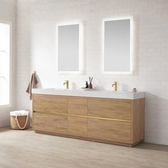 a bathroom with two sinks and mirrors on the wall