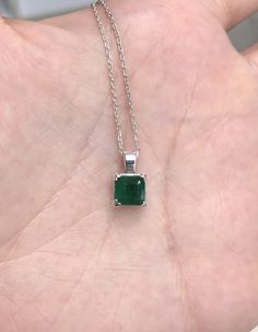 Featured is a stunning Asscher cut natural emerald necklace in fine .925 sterling silver. Displayed in the center is a dark-green emerald with very good clarity, accented by a simple four-prong silver mount, allowing for the emerald to be shown in full view. The earth mined emerald has a rich green color with excellent qualities. An 18-inch sterling silver chain will be provided with this beautiful pendant! This necklace is ideal for everyday use and is the perfect accessory to any outfit. The p Emerald Rings Silver, Formal Hallmarked Emerald Necklace, Emerald Necklace Silver, Classic Emerald Pendant Necklace, Elegant Emerald Pendant Gemstones, Hallmarked Round Emerald Necklace, Classic Emerald Cut Emerald Necklace For May Birthstone, Formal Silver Emerald-cut Emerald Necklace, Formal Silver Emerald Cut Emerald Necklace