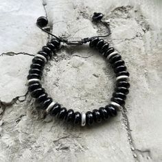 Expertly handcrafted with Black Onyx disk beads, our Explorer Bracelet is subtly exotic with hallmarks of a true adventurer. Pair this bracelet with the Explorer. Our Summit Series Bracelets, crafted by hand from premium natural stones found deep under the surface of earth, will inspire you to reach your highest potential with powerful manifestations and meaningful styles. Featuring a strong nylon string and finished with a stainless-steel drawstring lock, the bracelet slides over the wrist for Adjustable Black Beaded Round Bracelet, Black Bohemian Bracelets With Large Beads, Adjustable Round Black Beaded Bracelet, Black Hand Wrapped Spiritual Friendship Bracelets, Black Adjustable Rondelle Beaded Bracelets, Casual Black Friendship Bracelets With 8mm Beads, Handmade Black Friendship Bracelets For Everyday, Handmade Black Friendship Bracelets, Casual Black Hand Wrapped Bracelets